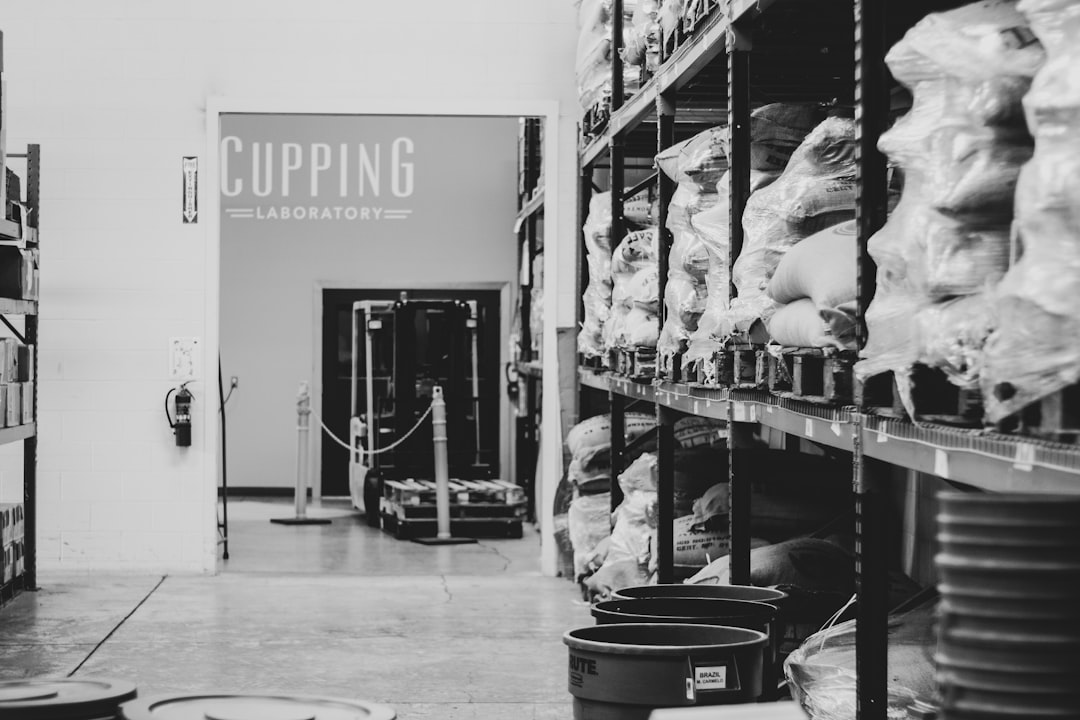 A variety of coffee beans in different storage containers, showcasing freshness and aroma.
